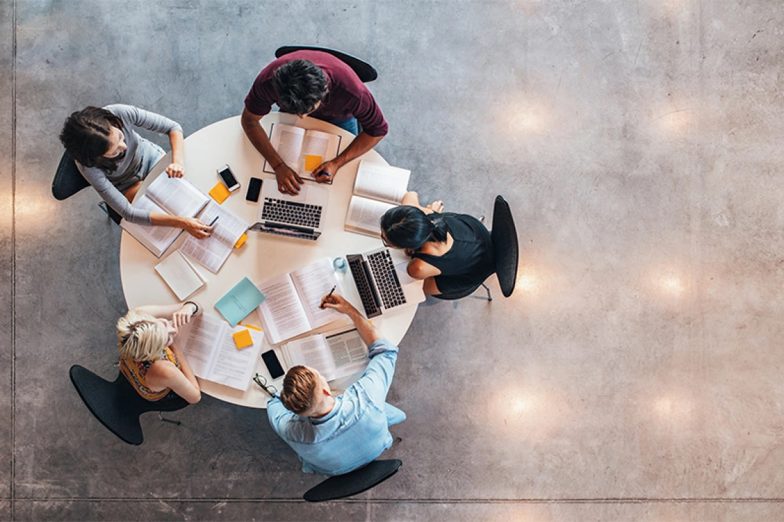 Aerial shot of a group of people working together at a table