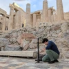 Person kneeling down working with equipment